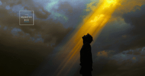 A person in grief looks up to the sky for hope and resilience